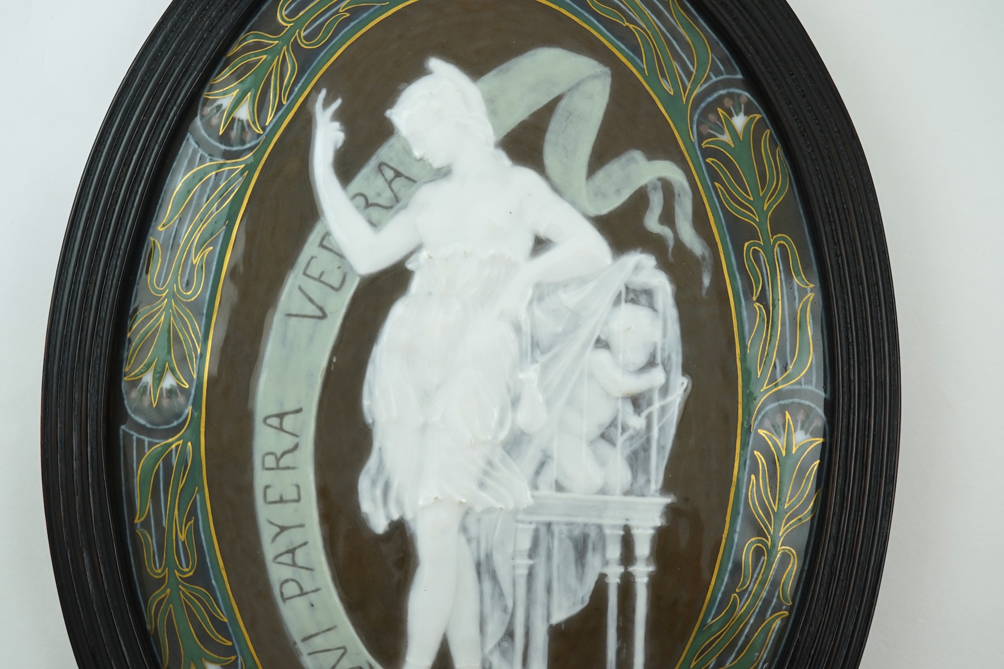 A late 19th century English pate sur pate oval porcelain plaque in the style of Louis Solon